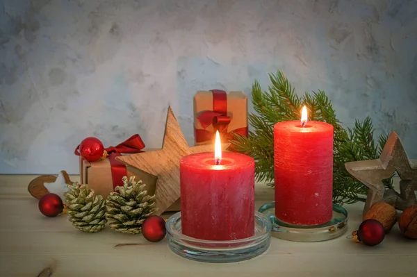 Two Red Candles Christmas Decoration Gifts Wooden Stars Cones Table — Stock Photo, Image