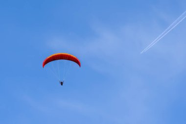 Paragliding in flight with airplane.