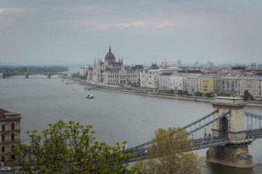 Budapeşte şehir manzarası Tuna Nehri üzerindeki meşhur zincir köprü ve bulutlu bir günde arka planda parlamento binası, Macaristan