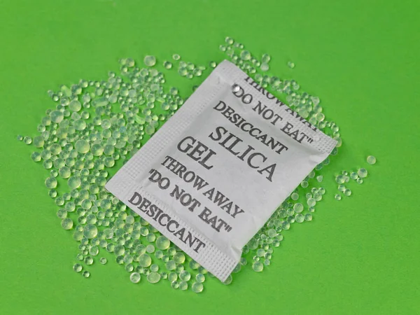 Silica gel desiccant beads against green background