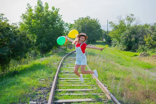 One girl jumps with balls on the railroad — Stock Photo, Image