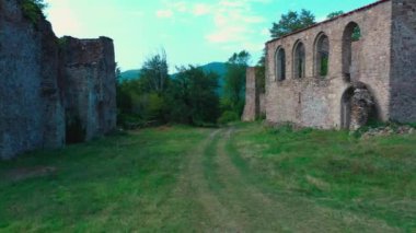 Dağlardaki eski bir kalenin kalıntıları yeşil ağaçlar.