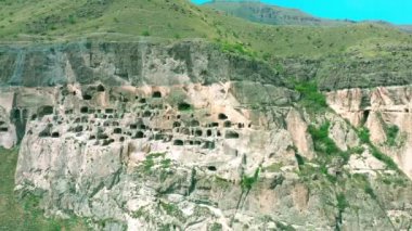 Drone flight near the city in the mountain cave