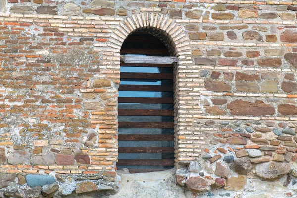 Beautiful arched door with lattice in uplistsikhe in georgia — Fotografia de Stock
