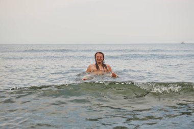 Denizde uzun saçlı genç bir adam. Yüksek kalite fotoğraf