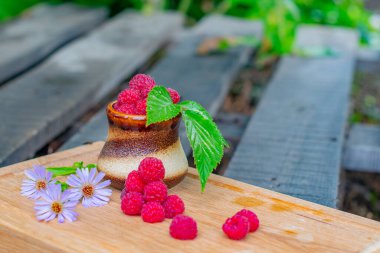 raspberries in a glass lie on a tray. High quality photo