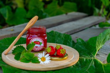 delicious jam and berries stand on a wooden board. High quality photo