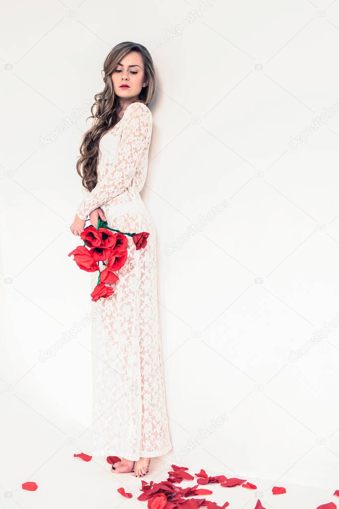a girl in a white lace dress with poppies