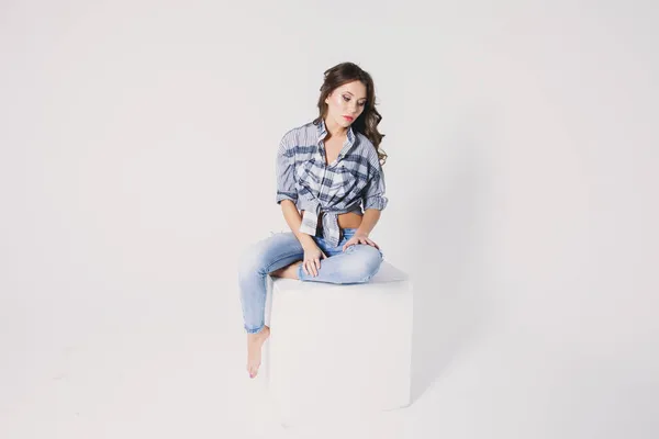 Girl Plaid Shirt Jeans Sits White Cube White Background — Stock Photo, Image