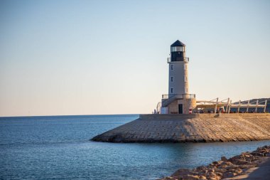 Lustica Körfezi, Karadağ - 1 Ekim 2021: Karadağ 'ın Lustica Körfezi' nde gün batımında restoranlı deniz feneri 