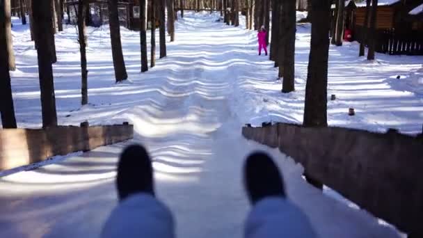 View of feet during rolling down the snowy hill in winter, Siberia — Stock Video