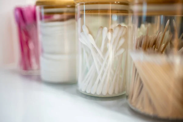 Containers with cotton swabs, tweezers, and brushes for styling eyebrows, accessories for the master of makeup and eyebrows — Stock Photo, Image