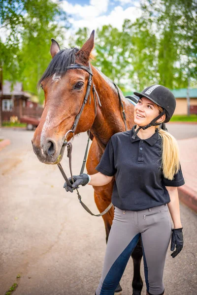 Lovely Young Woman Wearing Helmet Stroking Her Brown Horse High — Stockfoto