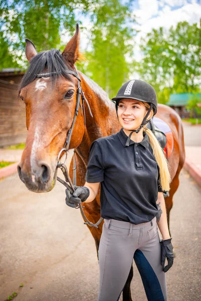 Lovely Young Woman Wearing Helmet Stroking Her Brown Horse High — Stockfoto