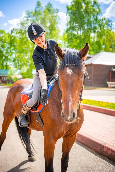 Lovely Young Woman Wearing Helmet Stroking Her Brown Horse High — Stockfoto