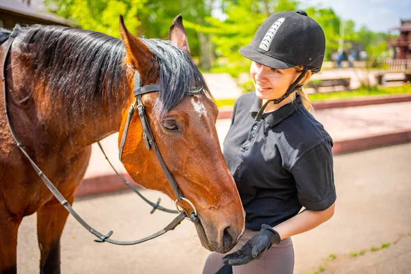 Lovely Young Woman Wearing Helmet Stroking Her Brown Horse High — Stockfoto