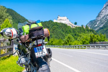 Dolomites Italy - July 2, 2022: Motorcycle with full equipment on the side of a rural mountain alpine road in area of Dolomites, Italy. High quality photo