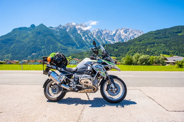 Dolomites Italy - July 2, 2022: Motorcycle with full equipment on the side of a rural mountain alpine road in area of Dolomites, Italy. High quality photo