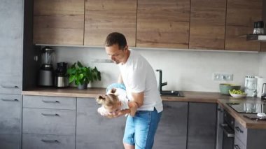 A happy father and little girl joyfully spending time in a modern kitchen. Happy family. Fathers day. High quality 4k footage