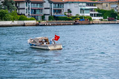 Istanbul, Turkey - May 29, 2022: Fishing boat and Cityscape of asian part of Istanbul from water, Turkey in a beautiful summer day. High quality photo
