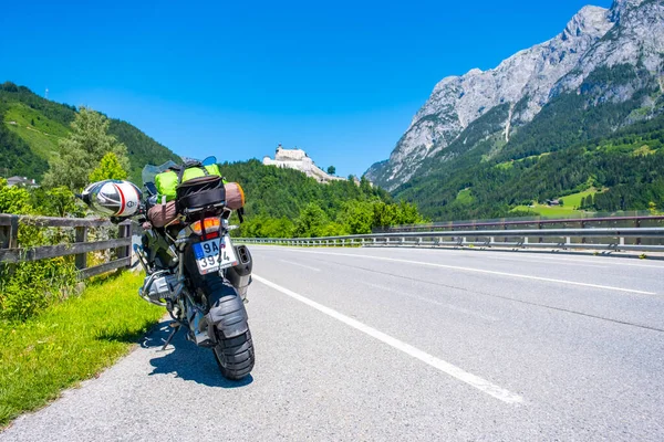 Dolomites Italy - July 2, 2022: Motorcycle with full equipment on the side of a rural mountain alpine road in area of Dolomites, Italy. High quality photo