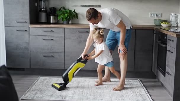 Father Daughter Having Fun Vacuum Cleaner While Cleaning Home Kitchen — Stok Video