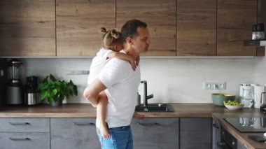 A happy father and little girl joyfully spending time in a modern kitchen. Happy family. Fathers day. High quality 4k footage