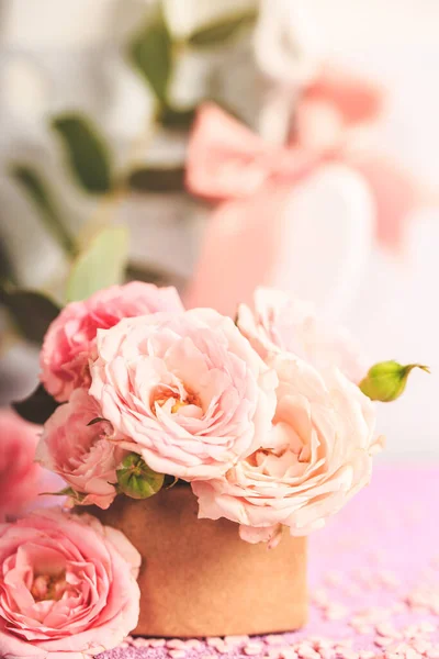 A bouquet of delicate pink roses. Festive card with pink flowers on a light background, vertical photo with copy space for text — ストック写真