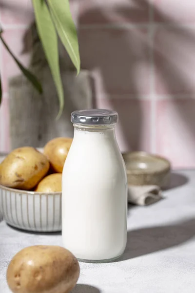 Bottle of potato milk on the table. Plant-Based Potato Milk Alternative, Vegan Milk vertical photo — Stock Photo, Image