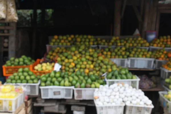 Blurred background of a Javanese fruit stall serving fruit at an Indonesian fruit market