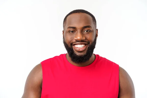 stock image Young fitness african black man in sport wear cheering carefree isolated over white background.