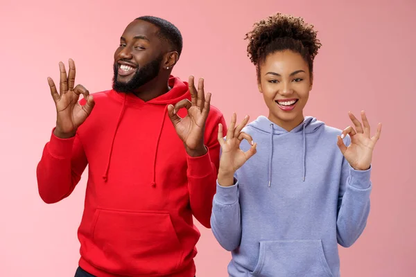 Everything perfect. Charming loving two couple relationship african american girlfriend boyfriend showing okay ok excellent gesture smiling approval assure parents they fine, pink background — Stock Photo, Image