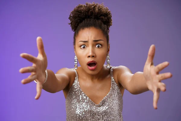 Close-up excited african woman in stylish fashionable silver glittering dress extend arms fowards frowning gasping look concerned worry friend fall standing concerned rushing help, blue background — Stock Photo, Image
