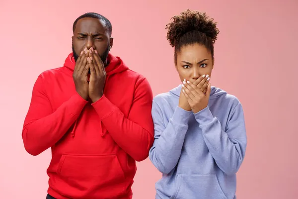 Romantic couple african american boyfriend girlfriend feel sick after eating dinner restaurant press palms mouth frowning wanna puke vomit, standing disgusted shocked pink background — Stock Photo, Image