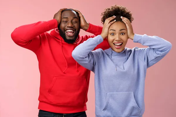 Waist-up happy charming surprised couple african american girlfriend boyfriend winning awesome gift lottery smiling impressed did not except win cannot believe luck grinning holding head shocked