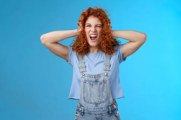 Wild daring rebellious cool stylish redhead curly girl having fun playful exciting mood touch hair yelling singing along awesome concert music enjoy positive summer vibes wear overalls — Stock Photo, Image