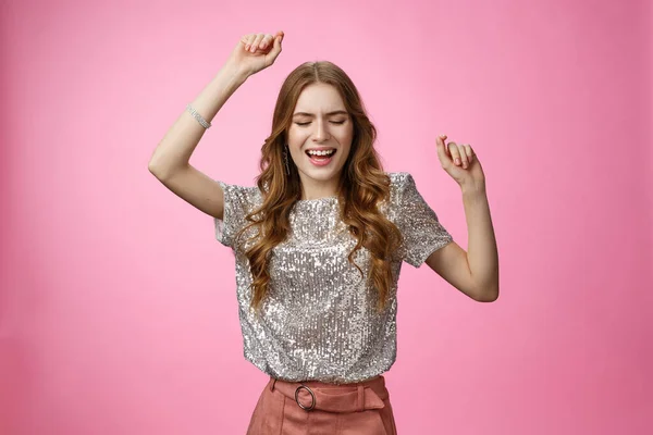 Attractive glamour female dancing dance-floor having fun rase hands up sky close eyes singing along songs enjoying awesome party cool music, wearing glittering blouse trendy skirt, pink background — Stock Photo, Image