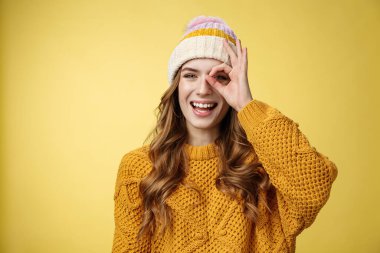 Dertsiz, neşeli, karizmatik, beyaz kadın kış tatili eğlenceli gösteri tamam. Çemberin içinden mutlu bir şekilde gül. Kocaman beyaz dişler, seyahat trenlerinin keyfini çıkar.