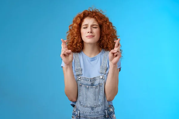 Intense nervous attractive redhead curly-haired hopeful focused girl praying supplicating asking god make dream come true cross fingers good luck anticipating important news wanna wish fulfill — Stock Photo, Image