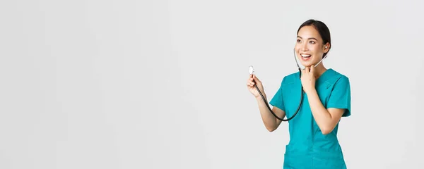 Covid-19, trabajadores de la salud y prevención del concepto de virus. Sonriente amigable mujer asiática médico escuchando a los pulmones del paciente durante el chequeo diario, usando estetoscopio, fondo blanco — Foto de Stock