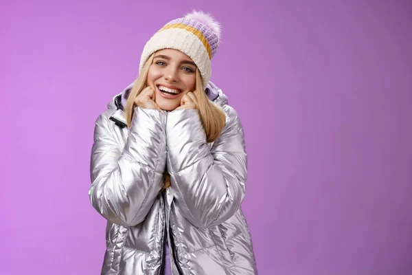 Delighted charming tender female in stylish cute hat silver shiny jacket lean chin hands smiling sighing enjoying watching lovely romantic scene wanna fall in love standing happily purple background — Stock Photo, Image