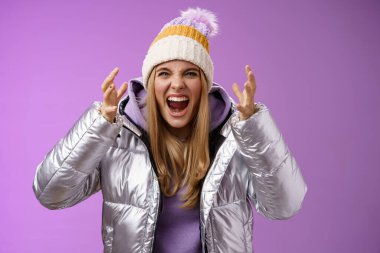 Outraged fed up pissed blond woman screaming out loud hateful bending forward shaking hands disrespect angry arguing heartbroken cry standing bothered quarreling, purple background