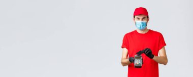 Bağlantı kurulamayan teslimat, ödeme ve kovid 19 sırasında online alışveriş, kendini karantina. Kurye güvenli ödeme emirleri verir, kredi kartıyla alır POS terminaline baskı yapar, maske takar ve eldiven giyer.