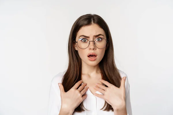 Close up of shocked, insulted woman in glasses, looking hurt and confused, standing over white background — Foto Stock