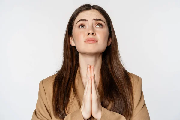 Hopeful corporate woman, student praying, begging god, looking up and pleading, standing over white background — Photo