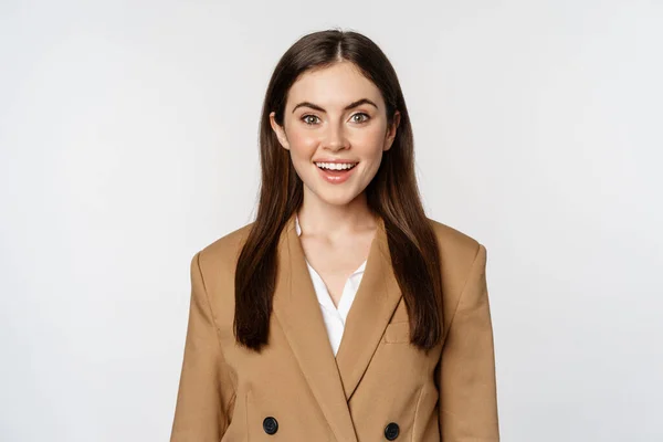 Portrait of business woman with enthusiastic face expression, smiling, looking confident, standing in suit over white background — Stock Fotó