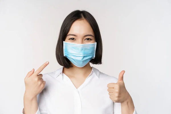 Portrait Asian Girl Medical Mask Shows Thumbs Sign Pointed Her — Stok Foto