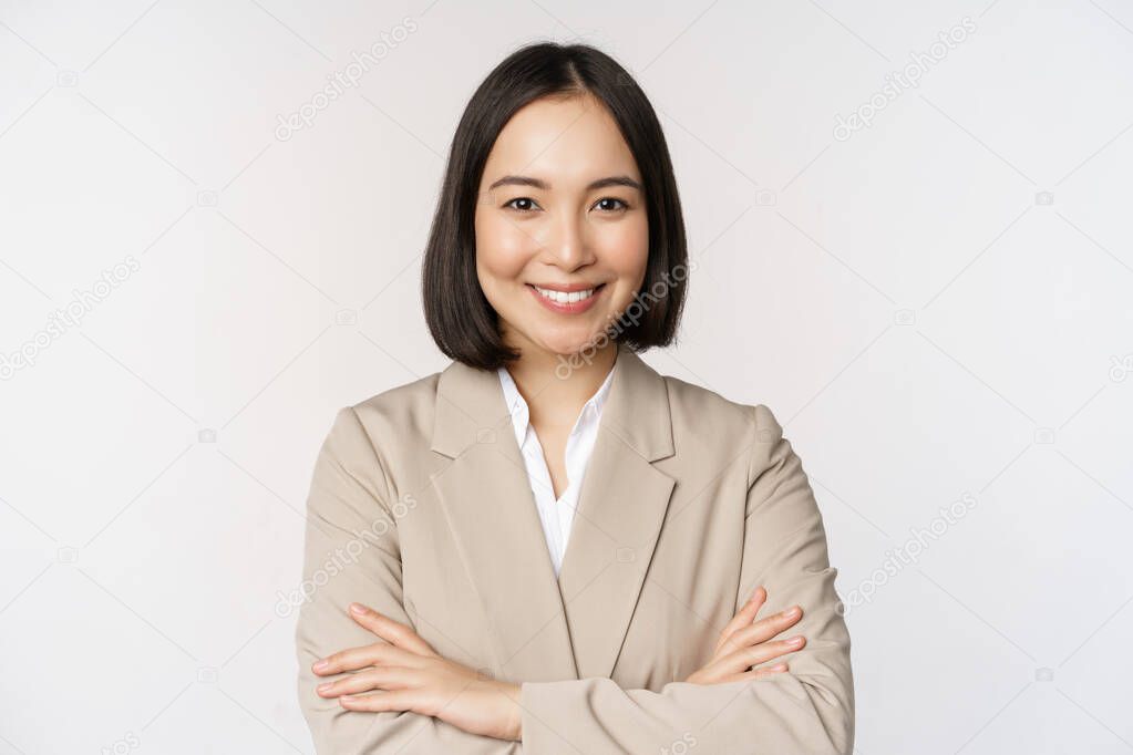 Confident female entrepreneur, asian business woman standing in power pose, professional business person, cross arms on chest, standing over white background.