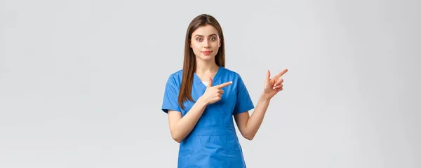 Εργαζόμενοι στον τομέα της υγείας, πρόληψη του ιού, ασφάλιση και ιατρική έννοια. Νεαρή νοσοκόμα ή γιατρός με μπλε τρίβει τα δάχτυλα δεξιά, προτείνουμε banner ή promo για τους ασθενείς κλινική — Φωτογραφία Αρχείου
