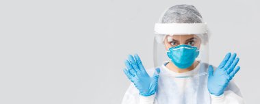 Covid-19, virüsün önlenmesi, sağlık, sağlık çalışanları ve karantina konsepti. Kişisel koruyucu ekipman, lastik eldiven ve solunum cihazında çalışan kadın doktor ya da hemşire.